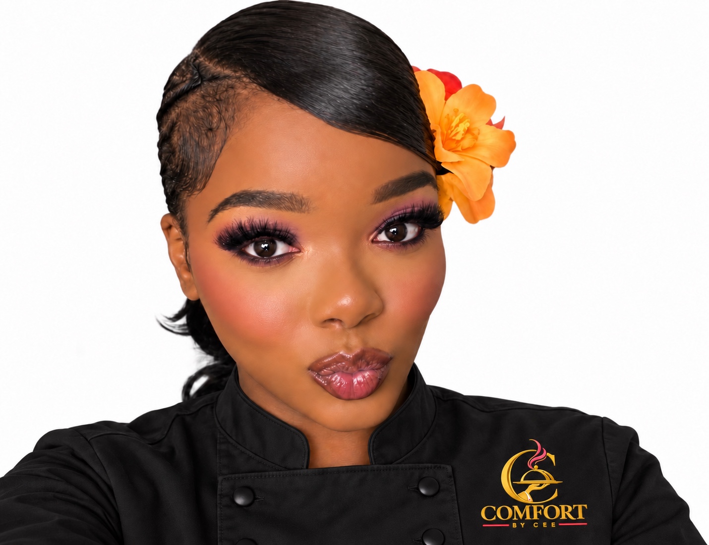 Cee wearing a black Comfort by Cee chef jacket and an orange flower